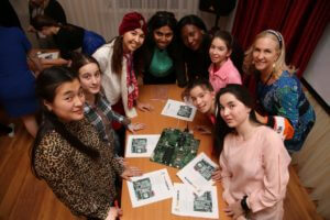 TechWomen mentors lead a hands-on motherboard workshop for girls at the 