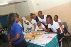 A high school team showcases their project during the Mombasa Girls in STEM Solve IT Fair on August 13.